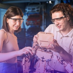 two individuals collaboratively assembling a wooden robot